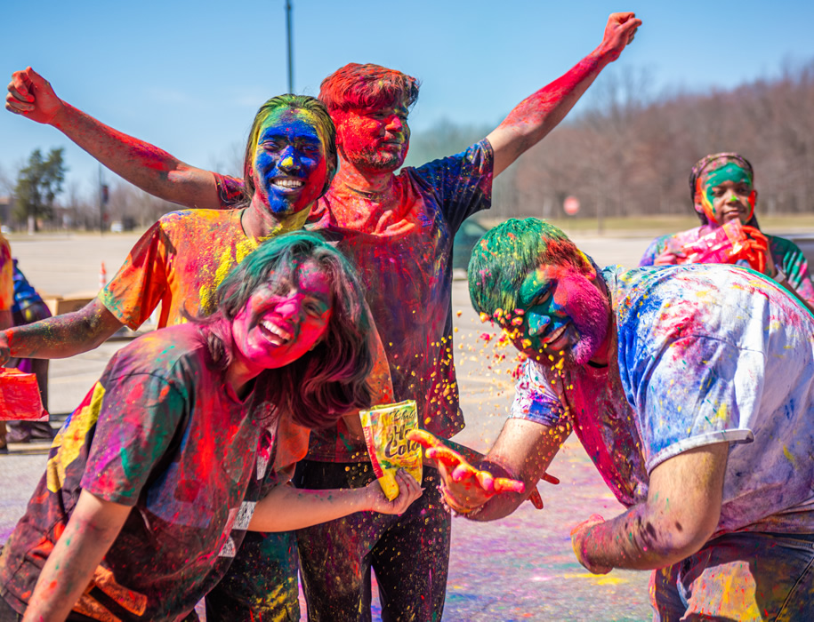 Students celebrating and covered in colors